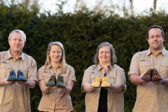 The LUKS Barefoot family team holding handmade shoes